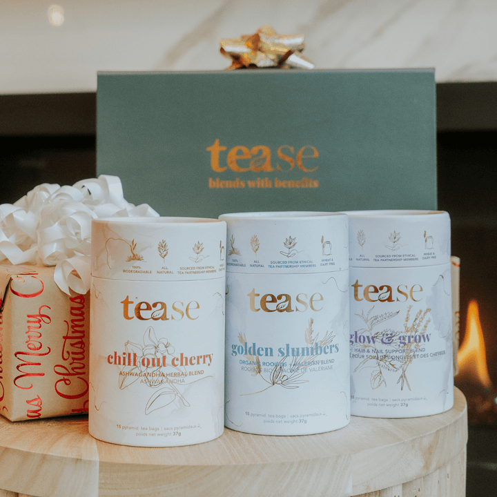 Tease Wellness Gift Box with Chill Out Cherry, Golden Slumbers, and Clove & Spruce tea blends in white canisters and deep.