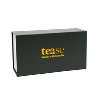 Tease Wellness gift box in black with gold logo, sleek rectangular packaging for tea blends.