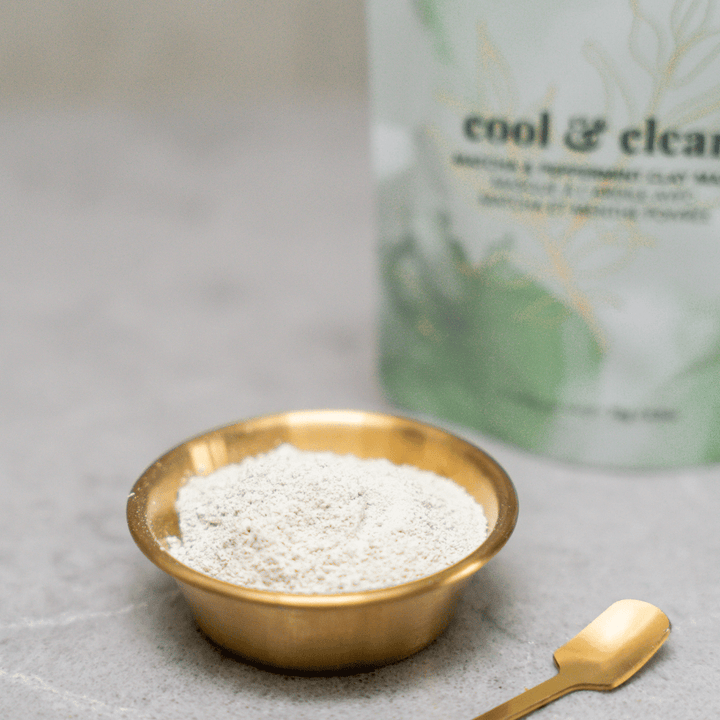 Tease Wellness Cool & Clear Matcha Face Mask powder in small gold bowl with gold spoon and green-white packaging.