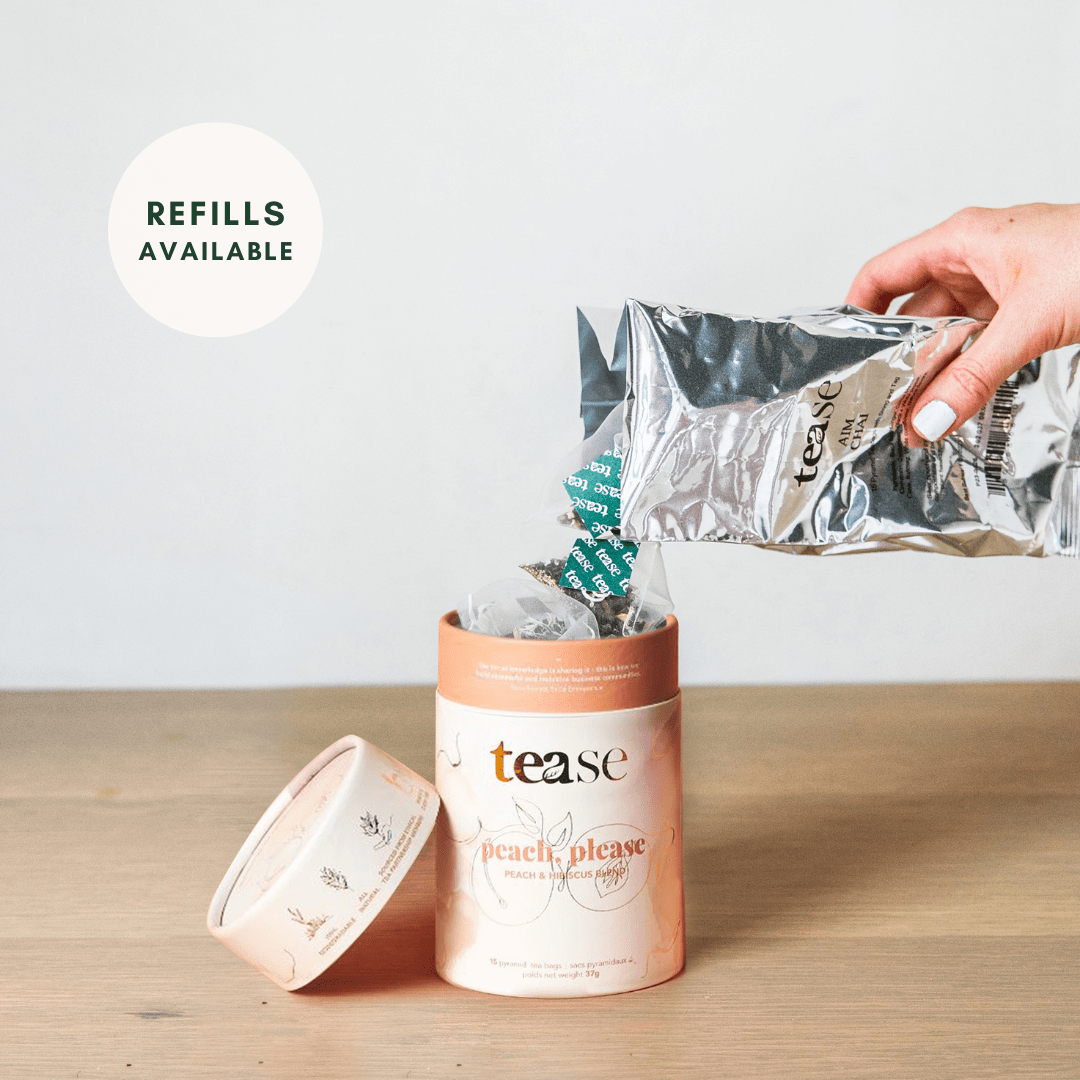 Tease Wellness Peach, Please tea blend in peach-colored tube with refill pouch pouring loose tea.