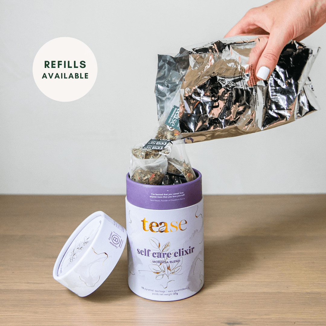 Tease Wellness Self Care Elixir tea blend in purple tube with loose tea leaves being poured, natural herb ingredients visible.
