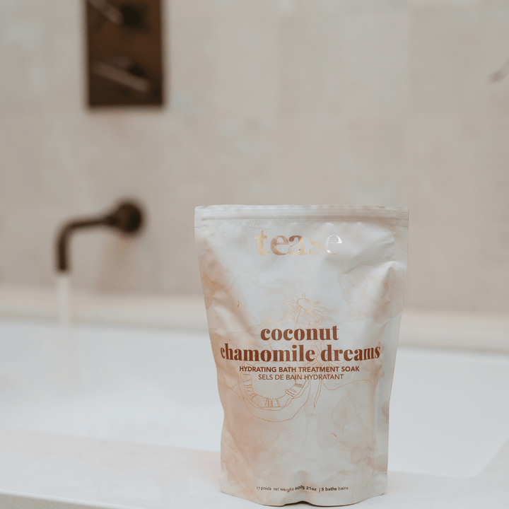 Tease Wellness Coconut Chamomile Dreams bath soak in white resealable pouch with gold and brown text.