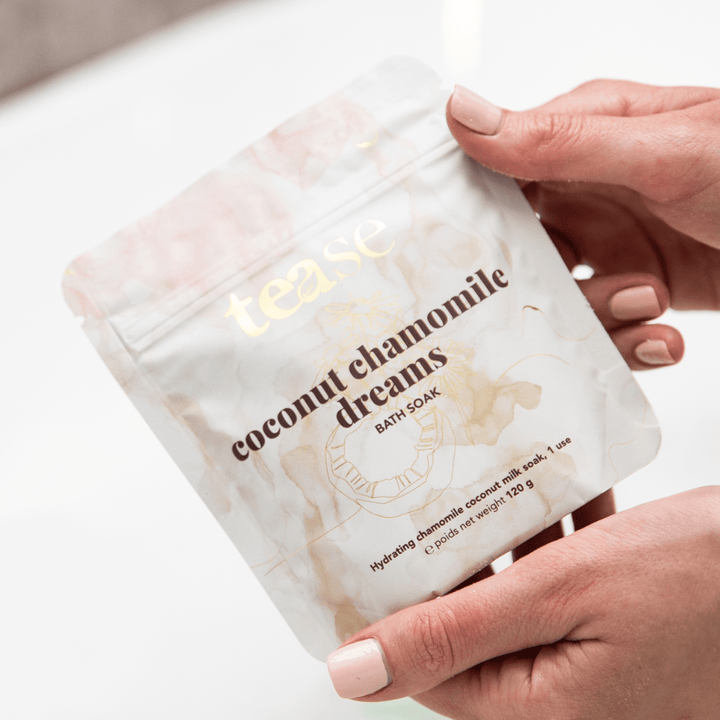 Tease Wellness Coconut Chamomile Dreams Bath Soak in a white resealable pouch with gold and brown text and subtle floral.